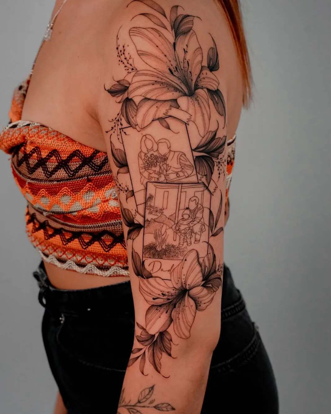 Botânico lily half sleeve tattoo on the upper arm
