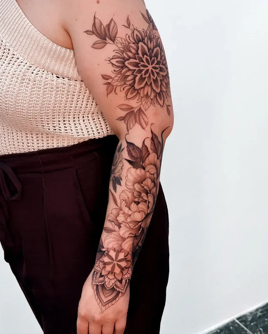 Botânico mandala and flower sleeve tattoo on the arm