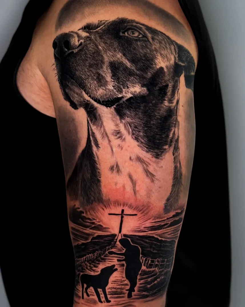 Realismo dog portrait and seaside scene tattoo on the upper arm