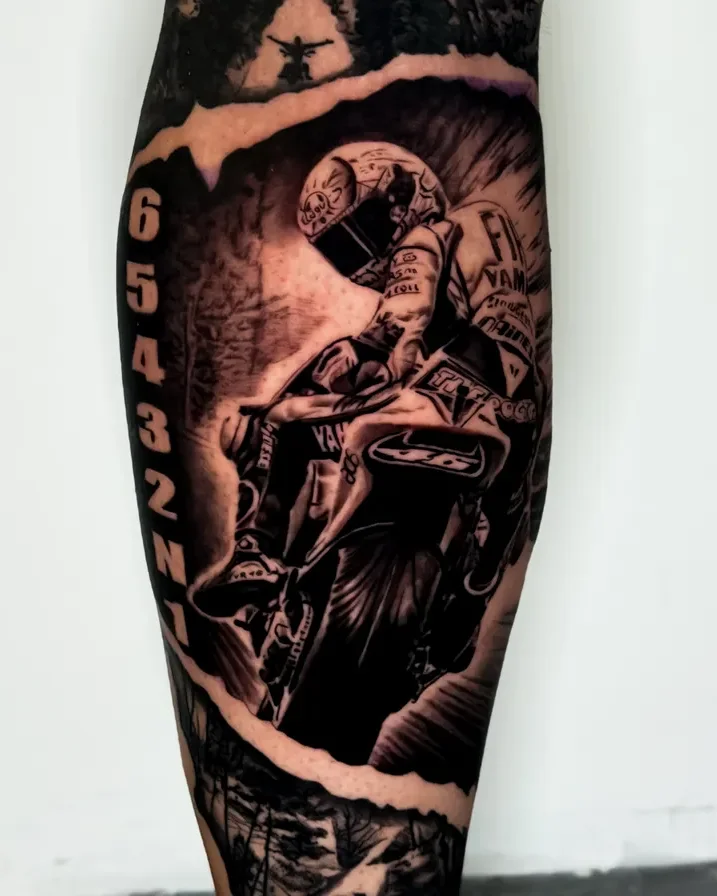 Realismo motocross rider and mountain scene tattoo on the calf