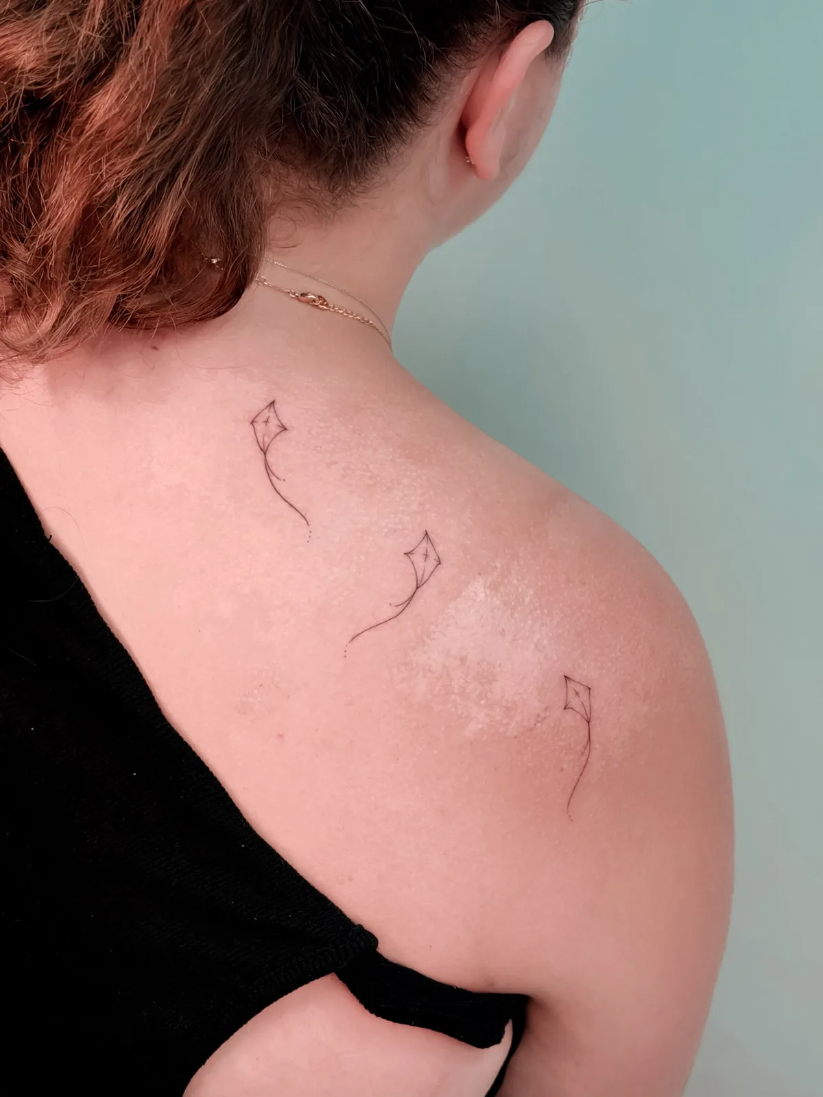 Fine line trio of kites tattoo by Hugo Gonzalez, Madeira