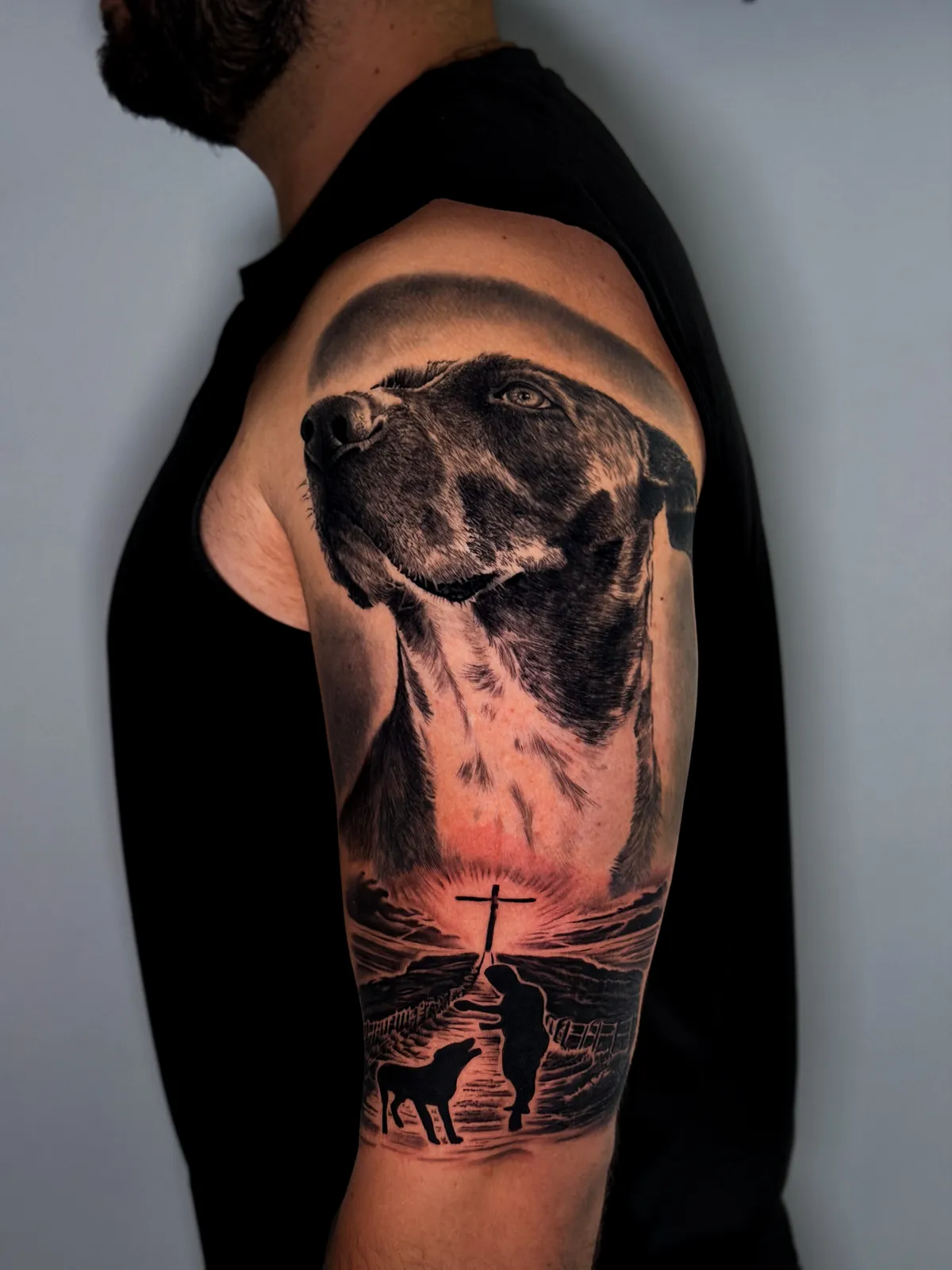 Realistic dog portrait tattoo with seaside scene by Hugo Gonzalez