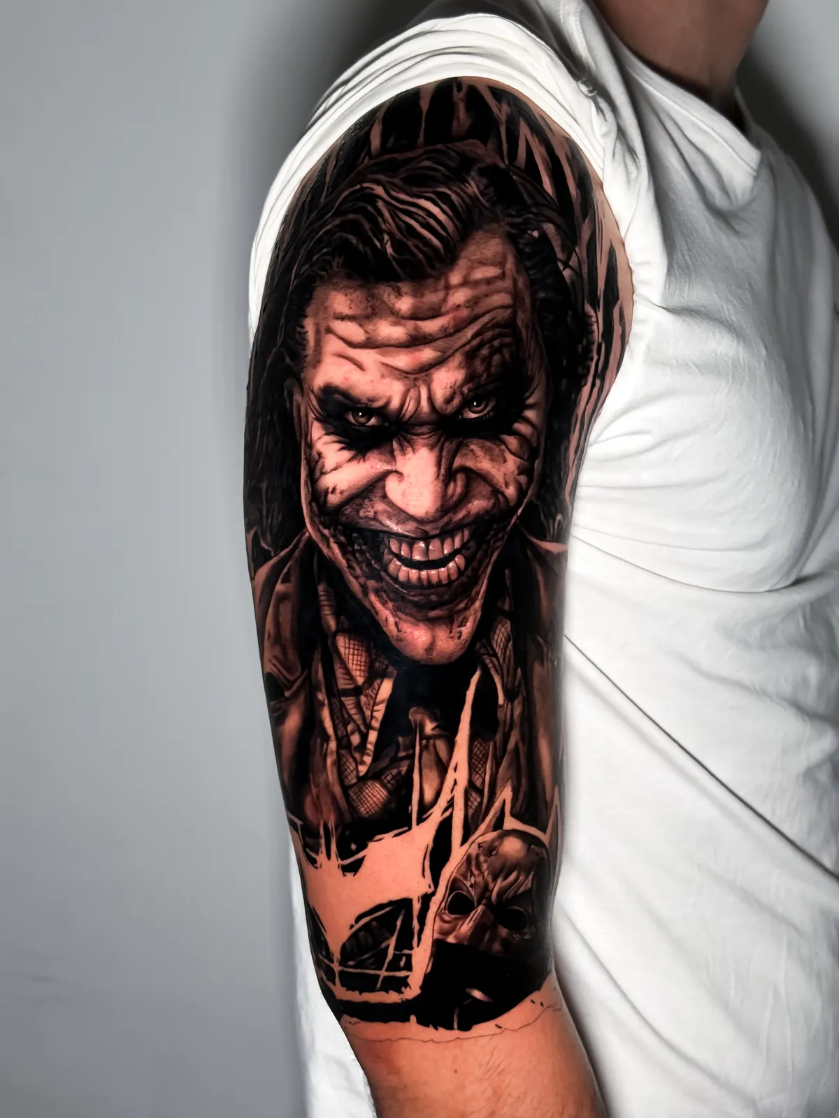 Black and grey Joker portrait tattoo by Hugo Gonzalez