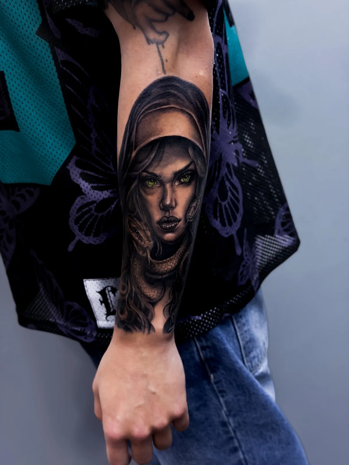 Black and grey veiled portrait tattoo on the forearm by Hugo Gonzalez